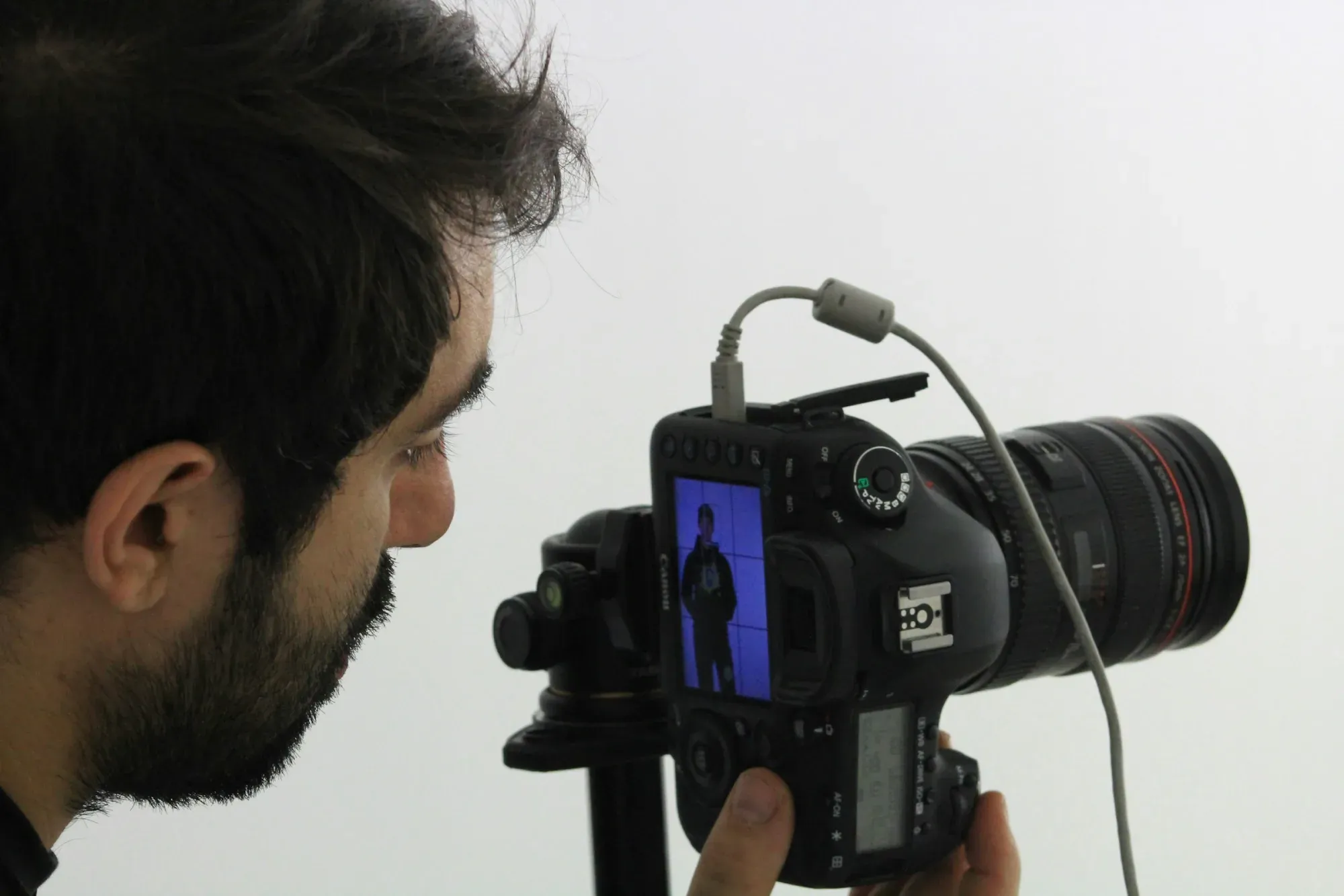man using black DSLR camera