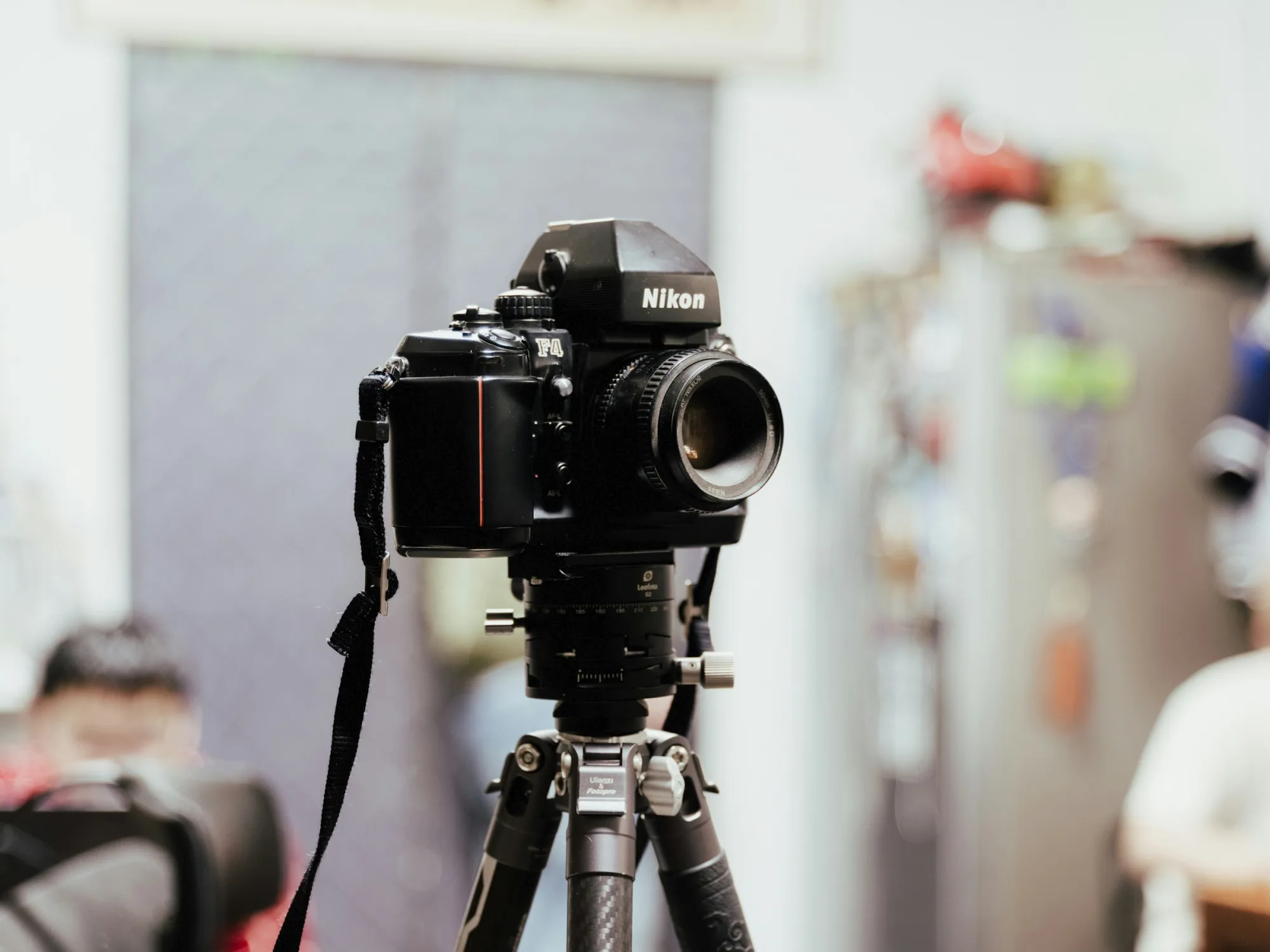 A black nikon camera on a tripod